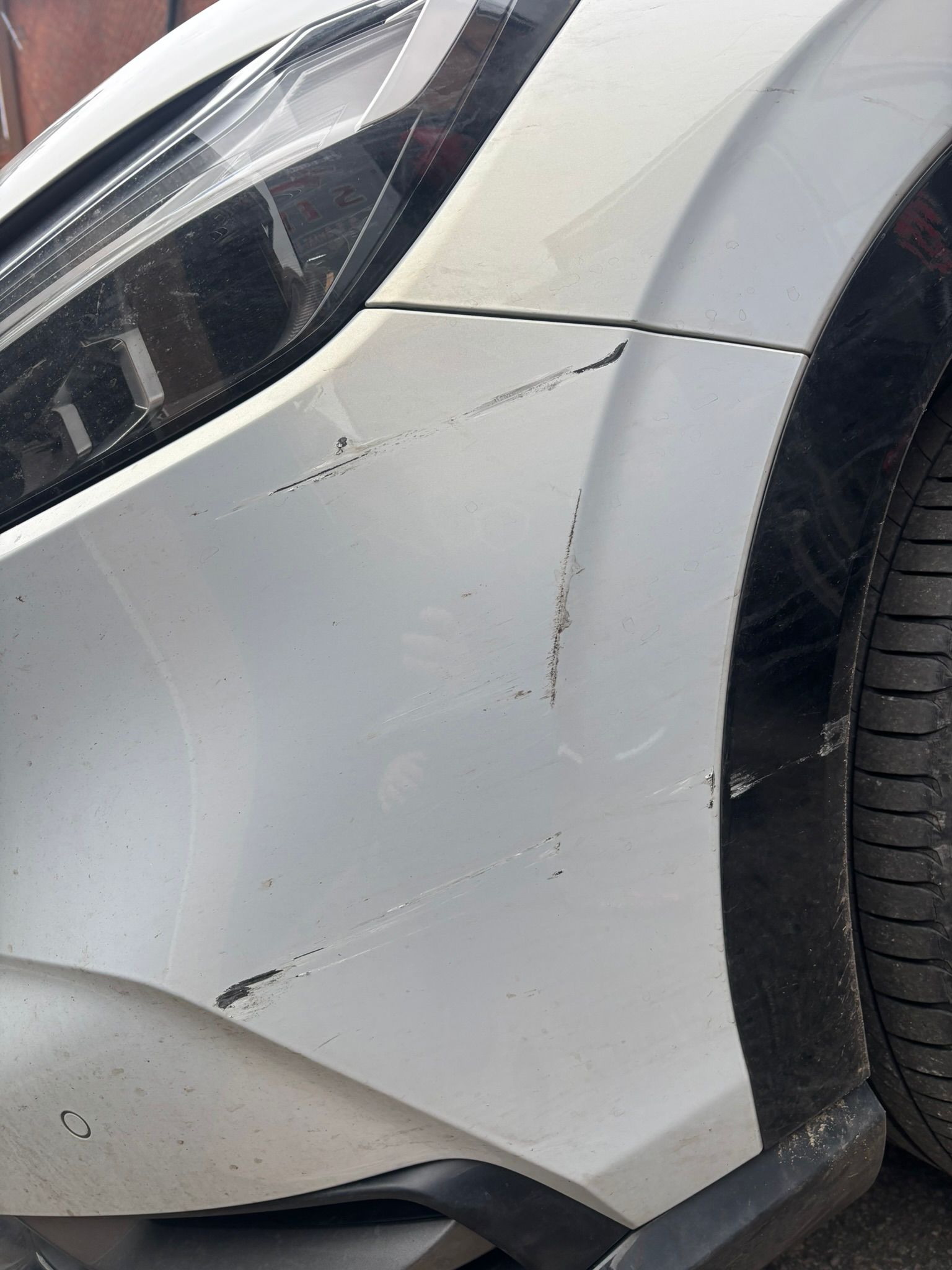 Scuffed car bumper prior to respray